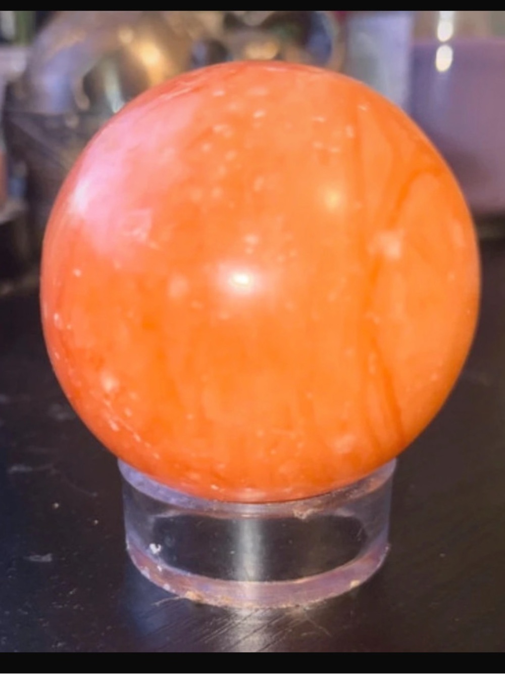 Orange calcite sphere with stand